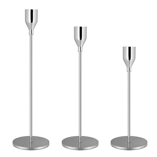 Three silver candlesticks at different heights.